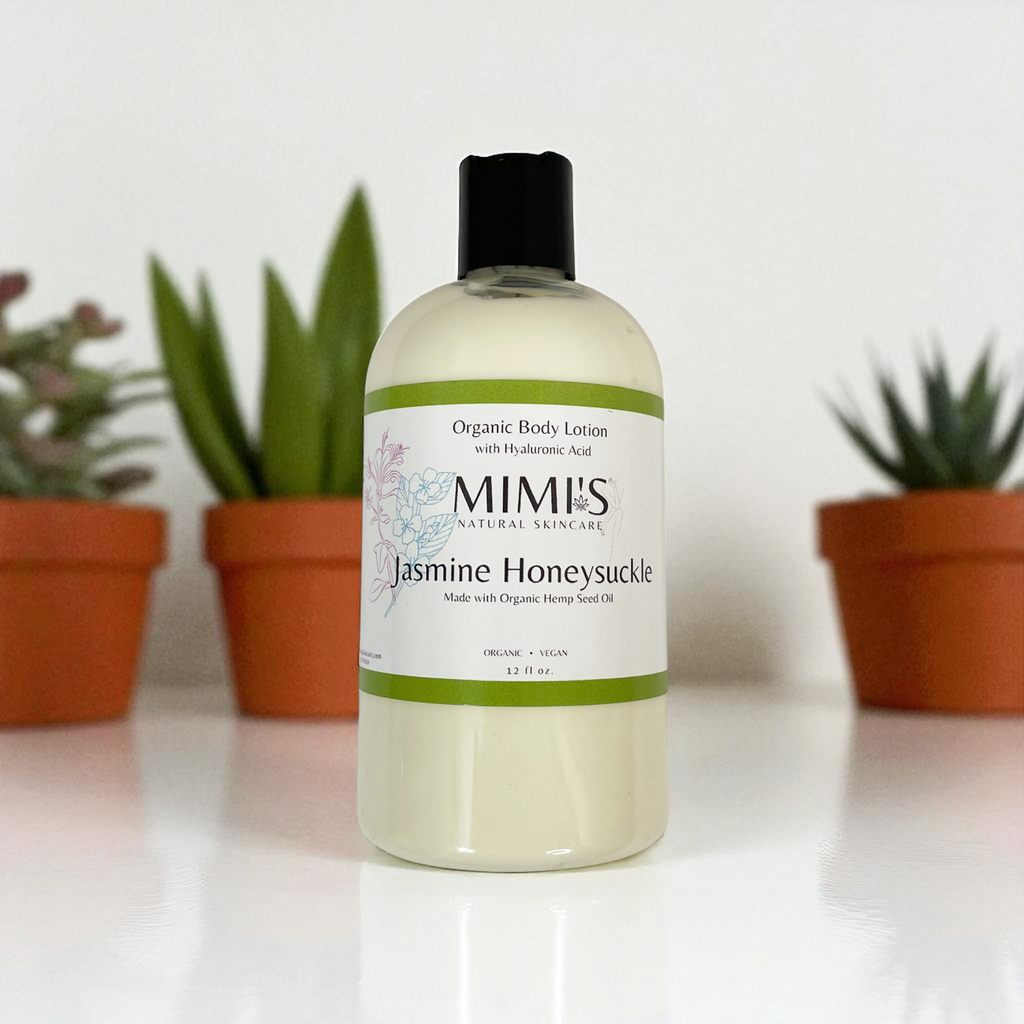 Bottle of MIMI's Jasmine Honeysuckle organic body lotion with plants in the background