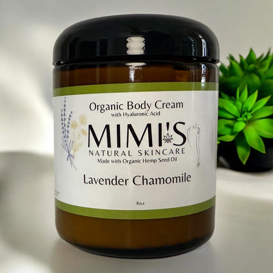 Jar of Mimi's Organic Body Cream with Hyaluronic Acid on a neutral background