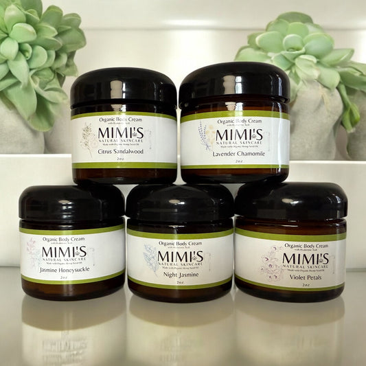 Set of Mimis Organic Body Cream jars with succulents in the background